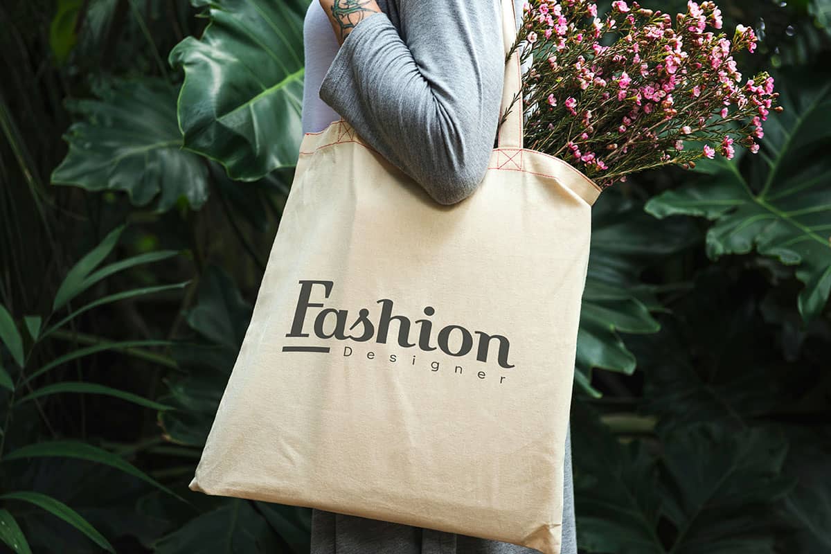 tote-bag-with-logo A person holding a San Antonio custom merchandise tote bag.